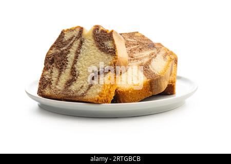 Marble sponge cake. Cake with cocoa and vanilla taste isolated on plate on the white background. Stock Photo
