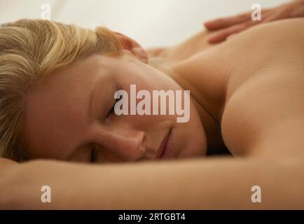 Close up of a young woman receiving a back massage Stock Photo