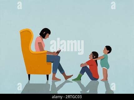 Mother in armchair reading book to daughter and son at home Stock Photo