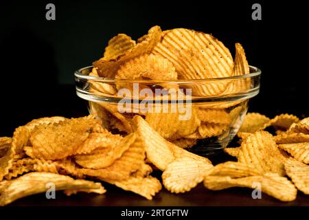 Potatoes Chips. Fried potatoes in a deep transparent bowl, Potato chips in a clear glass bowl Stock Photo