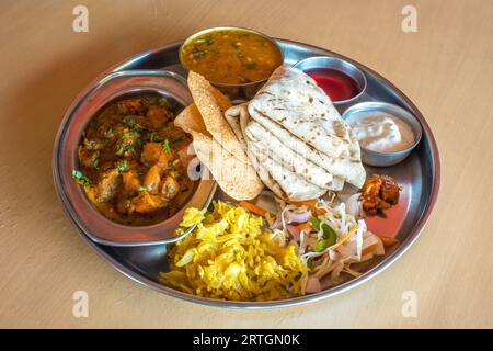 Shot of healthy and tasty Indian vegetarian Lunch/dinner platter with many variety of appetizing vegetarian dishes to tangle your taste buds and give Stock Photo