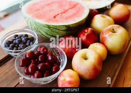 Delicious summer fruits on wooden table Stock Photo