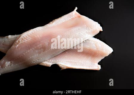 Whitefish fillets on the black background. Top view. Stock Photo