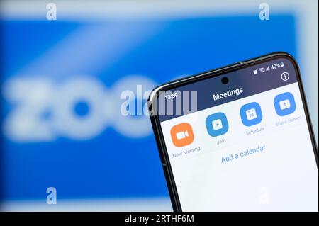 New York, USA - August 20, 2023: Making new meeting in zoom app on smartphone display close up with blurred logo background Stock Photo