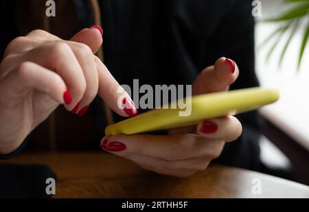 Woman uses a smartphone Stock Photo