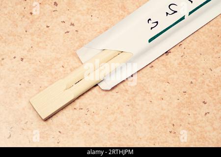 Chopsticks in paper wrapper Stock Photo