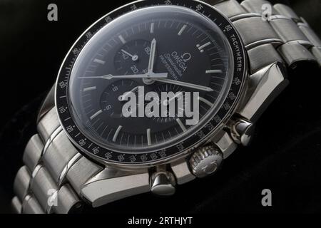 Milan, Italy - September 12, 2023: close up on the dial of a stainless steel Omega Speedmaster Professional Moonwatch resting on a black background. Stock Photo