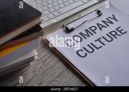 Close up image of paper clipboard with text COMPANY CULTURE on office desk Stock Photo