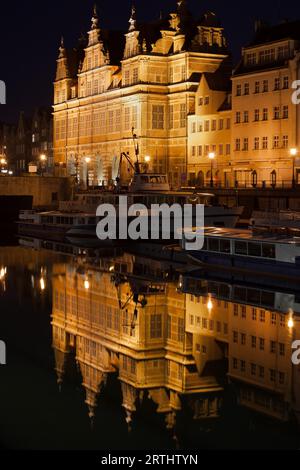 The Green Gate (Polish: Zielona Brama) illuminated at night in Gdansk, Poland, city landmark, Flemish mannerism architecture, reflection on Motlawa Stock Photo