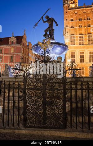 Neptune Fountain at night in city of Gdansk in Poland, bronze statue of the Roman God of the Sea in the Old Town Stock Photo