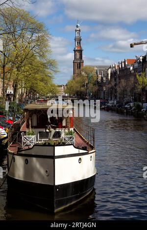 View along the Prinsengracht towards the Westerkerk in Amsterdam, Netherlands in spring. View along the Prinsengracht towards the Westerkerk in the Stock Photo