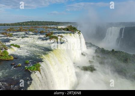 Close view of one of the Cataratas water falls under blue sky and a lot of water mist in the air at the Foz do Iguassu park, Brazil Stock Photo