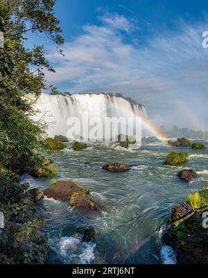 Close view of one of the Cataratas water falls under blue sky and a lot of water mist in the air at the Foz do Iguassu park, Brazil Stock Photo