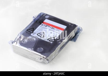 Close up view of high capacity computer hard drive 3.5' in LDPE Packaging isolated on white background. Stock Photo