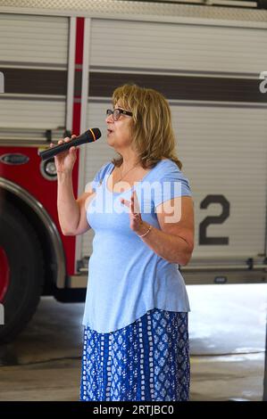 911 commemoration ceremony at Barnstable, MA Fire Headquarters on Cape Cod, USA. Singing the National Anthem at the event Stock Photo