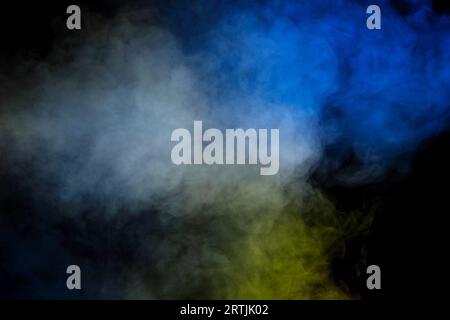 Blue and yellow steam on a black background. Copy space. Stock Photo