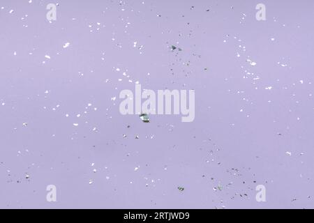 Purple festive background with silver confetti. Holiday concept. Stock Photo