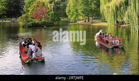 Tourists taking a ride on famous Swan Boats established in 1877 in Boston Public Garden, USA Stock Photo