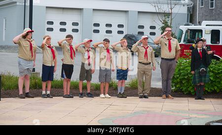911 commemoration ceremony at Brewster, MA Fire Headquarters on Cape Cod, USA. Boy Scouts standing at attention, saluting!.. Stock Photo