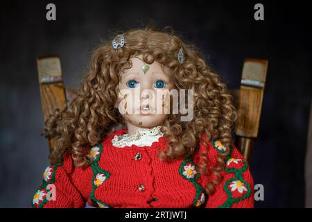 Vintage porcelain doll baby girl with blue eyes, blonde curls