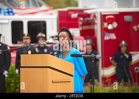 911 commemoration ceremony at Brewster, MA Fire Headquarters on Cape Cod, USA. Singing the National Anthem at the ceremony's start Stock Photo