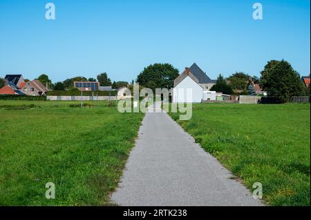 Essen, Antwerp Province, Belgium, September 9, 2023 - Bending country road through the fields at the Dutch Belgian border Stock Photo