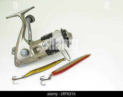 fishing wheel with two golden lures isolated on white Stock Photo