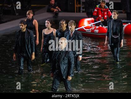 Berlin, Germany. 13th Sep, 2023. Members of the ensemble perform at the photo rehearsal of the opera 'The Raft of the Medusa' in Hangar 1 on the grounds of the former Tempelhof Airport. The piece will premiere on September 16, 2023. Credit: Monika Skolimowska/dpa/Alamy Live News Stock Photo