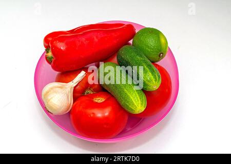 Fresh organic ripe raw vegetables pile in plastic bowl isolated on white Stock Photo