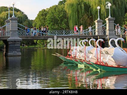 Tourists enjoying walking in Boston Public Garden including the lake, Swan Boats and the bridge, USA Stock Photo