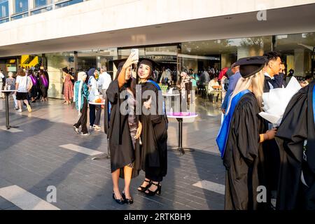 Two Female Degree Students Pose For A Selfie At Their Graduation Ceremony, The Southbank, London, UK. Stock Photo