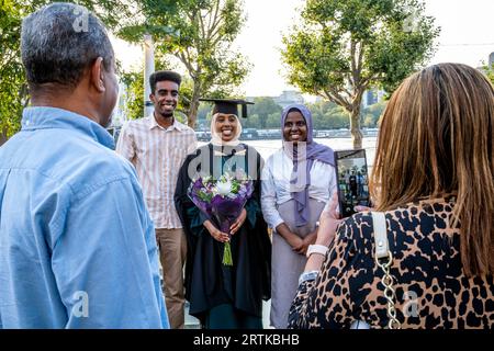A Muslim Degree Student Poses For A Photo With Her Family At Her Graduation Ceremony, The Southbank, London, UK. Stock Photo