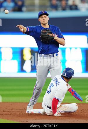 Texas Rangers' Corey Seager, left, greets Marcus Semien after his solo home  run off Cleveland Guardians starting pitcher Kirk McCarty during the third  inning of the second game of a baseball doubleheader