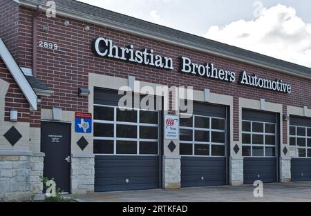 Houston, Texas USA 07-30-2023: Christian Brothers Automotive workshop exterior and garage doors in Houston, TX. Auto repair business chain est. 1982. Stock Photo