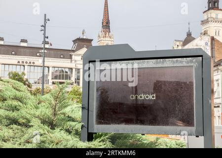 Picture of a screen with the logo of android in a novi sad information screen. Android is a mobile operating system based on a modified version of the Stock Photo