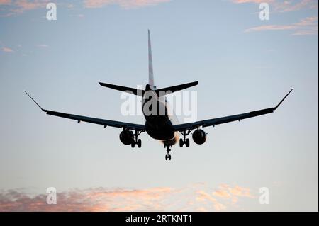 Plane with landing gear down approaching LAX airport in Los Angeles California, USA Stock Photo