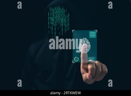 Hacker is scanning fingerprints in the dark. Concept of information security in internet networks and espionage. Stock Photo