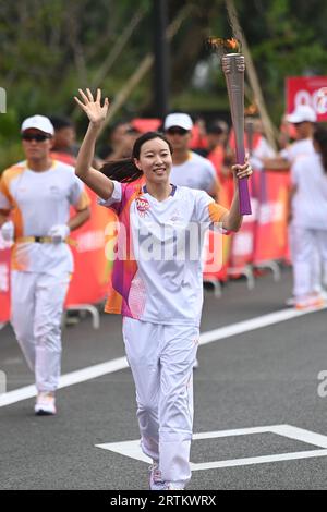 Taizhou, China's Zhejiang Province. 14th Sep, 2023. Torch bearer Feng Yu runs with the torch during the torch relay of the 19th Asian Games in Taizhou, east China's Zhejiang Province, Sept. 14, 2023. Credit: Huang Zongzhi/Xinhua/Alamy Live News Stock Photo