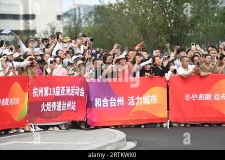 Taizhou, China's Zhejiang Province. 14th Sep, 2023. People watch during the torch relay of the 19th Asian Games in Taizhou, east China's Zhejiang Province, Sept. 14, 2023. Credit: Huang Zongzhi/Xinhua/Alamy Live News Stock Photo