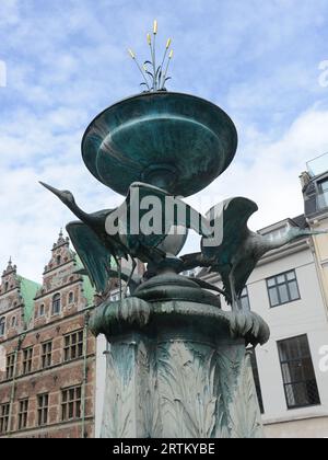 The Stork fountain is decorated with birds & frogs on Amagertorv pedestrian street in Copenhagen, Denmark. Stock Photo