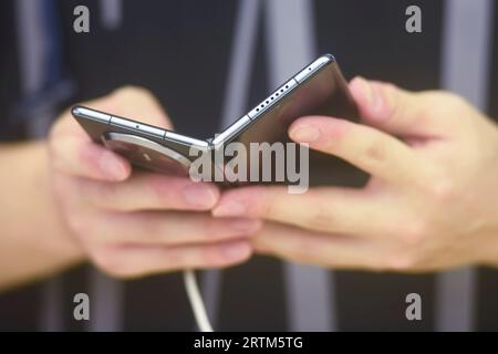 HANGZHOU, CHINA - SEPTEMBER 14, 2023 - Customers experience Huawei's latest foldable phone Mate X5 at a Huawei store in Hangzhou, East China's Zhejian Stock Photo