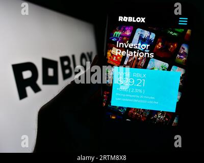 Person holding smartphone with website of US video games company Roblox  Corporation on screen in front of logo. Focus on center of phone display  Stock Photo - Alamy