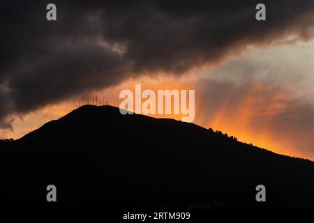 Sunbeam sunset and thunder storm clouds above Pichincha Volcano, Quito, Ecuador. Stock Photo