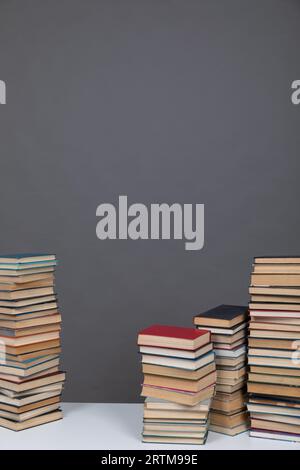 a large number of books on a gray background in the library of science knowledge reading Stock Photo