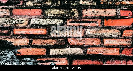 An old brick wall in a sunny outdoor location Stock Photo