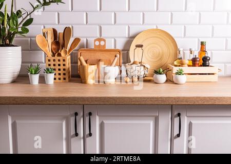 A lot of different kitchen utensils and items made from natural materials on the kitchen countertop. ecologically clean kitchen. Eco style Stock Photo