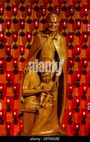 Statue in St AnthonyÕs catholic church, Leuven, Belgium : Holy Family or Missionary with woman and child Stock Photo