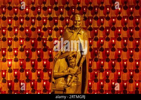 Statue in St AnthonyÕs catholic church, Leuven, Belgium : Holy Family or Missionary with woman and child Stock Photo