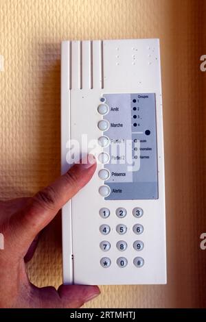 Man  Setting Control Panel On Home Security System.  France. Stock Photo