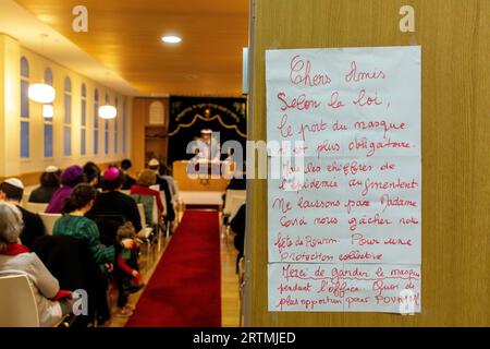 Purim celebration in Beth Yaacov synagogue, Paris, France. Sign recommending wearing face masks Stock Photo